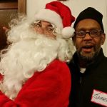 James Johnson posing with Santa